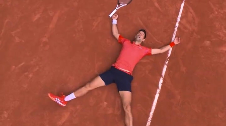 Moment Novak Djokovic lays down on tennis court after historic French Open win