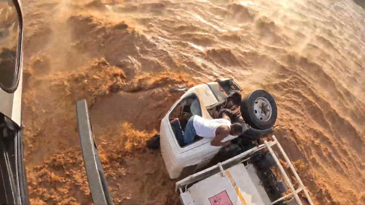 Watch: Daring rescue of driver trapped in rushing flood waters