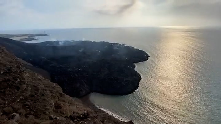 Volcanic gas rises from 'new island' created by La Palma volcano lava