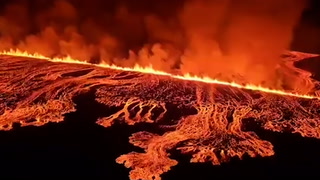 Fast-travelling molten lava flows metres from Iceland defence barriers
