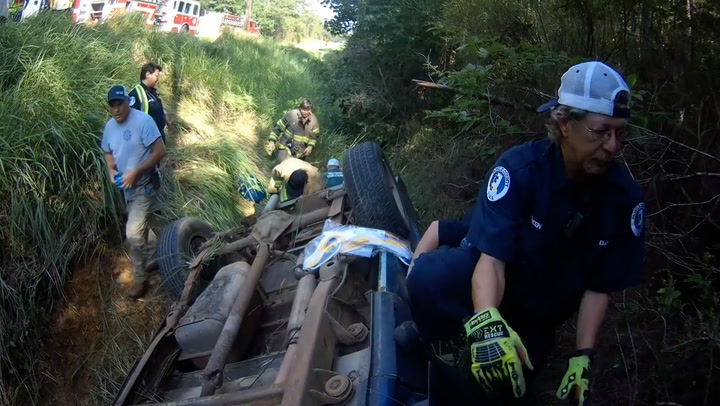 Two people rescued from flipped car in 15ft ditch by firefighters