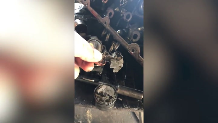 Mechanic fixing motorcycle finds beer bottle caps used in engine