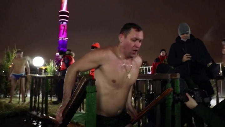 Russians plunge into ice-cold water to mark Epiphany