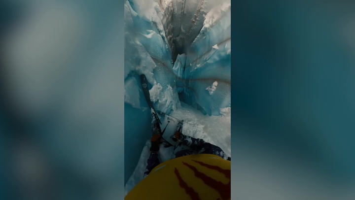 Heart-stopping moment skier falls into glacier crevasse