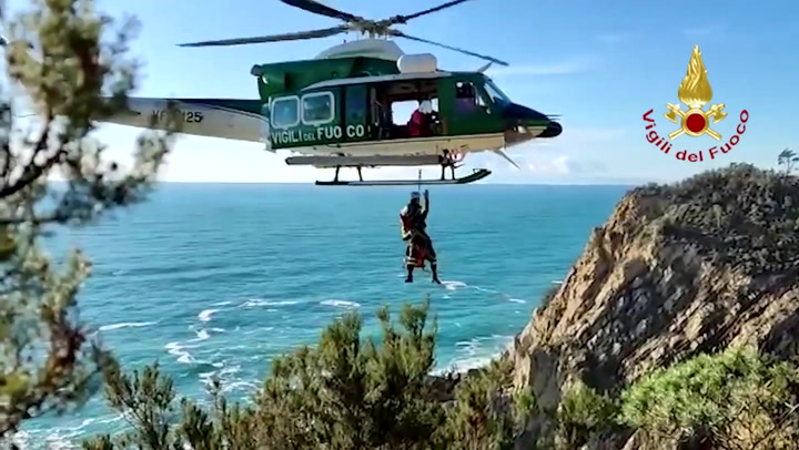 Helicopter lifts woman to safety after she gets stranded on cliff in Italy