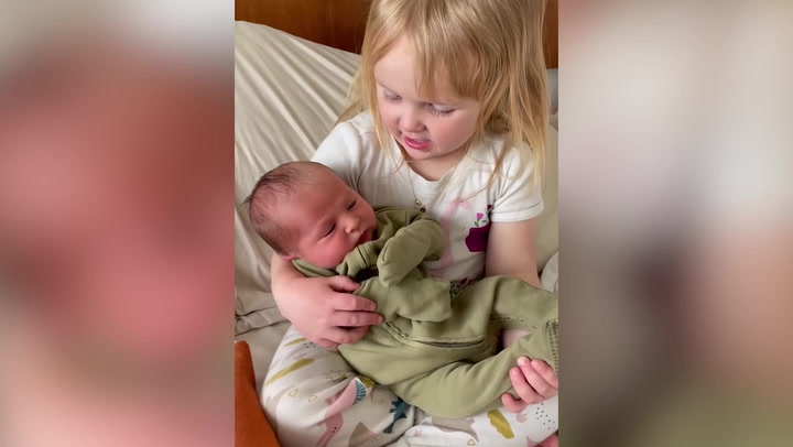 Cute moment four-year-old tells newborn brother she will teach him how to eat snow