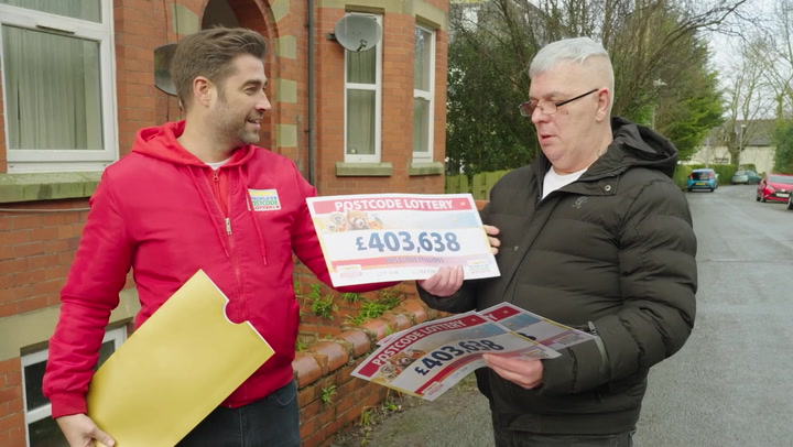 Biggest Postcode Lottery winner 'still in shock' as he's presented cheque