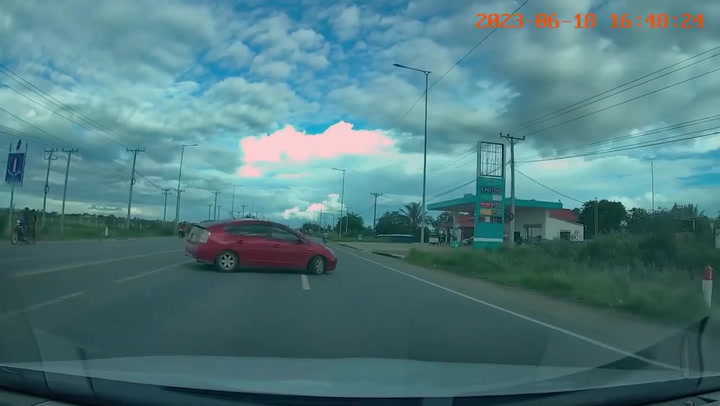 Shocking moment motorcycle rider crashes into sedan making a turn across road