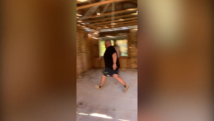 Australian builder appears to knock down brick wall by running headfirst into it