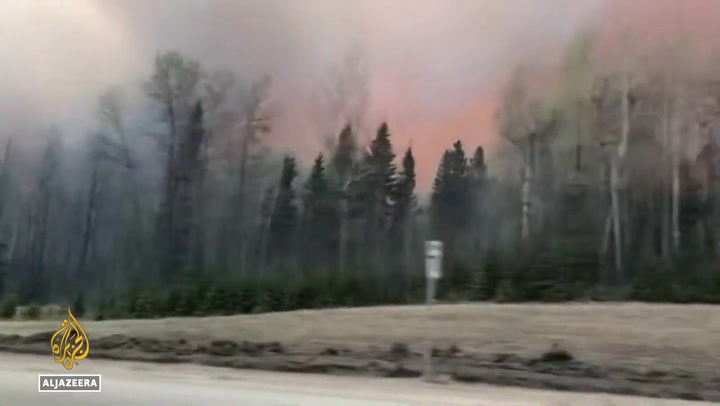 Canadian fire crews battle blazes in western province of Alberta