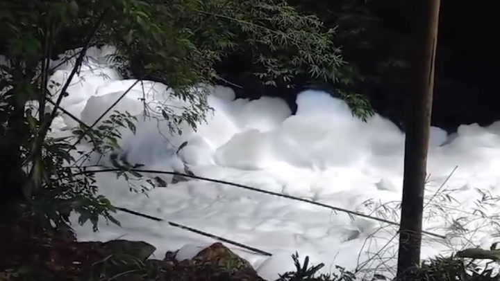 Acid spill covers Brazil river in thick white foam