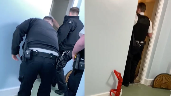 Moment police break into flat where woman’s body found after more than two years
