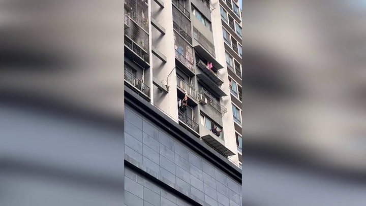 Hero neighbour saves girl hanging from balcony by her neck