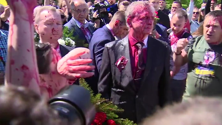 Russian ambassador to Poland covered in paint by protesters at war memorial event