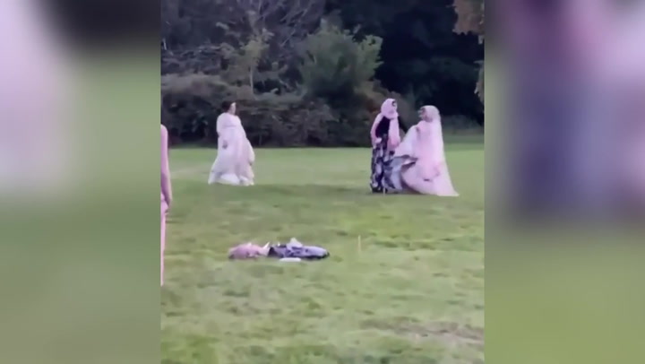 Woman plays rounders in her 24kg Pakistani wedding dress