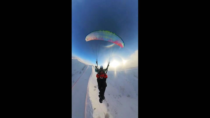 Stunning Ice Halo Spotted During Paraglider Ride At Jiangjunshan Mt. In Xinjiang, China