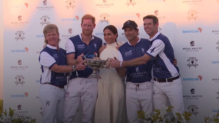 Meghan Markle kisses Prince Harry as she presents him with polo trophy at Miami charity match