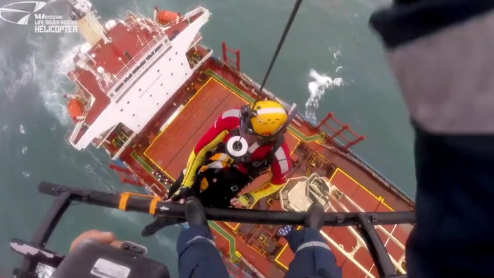 Emergency services lowered onto stranded cargo ship in attempt to rescue crew members