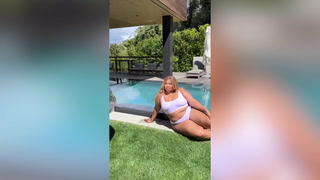Lizzo swaps weights for wine bottle in satirical weight-loss video