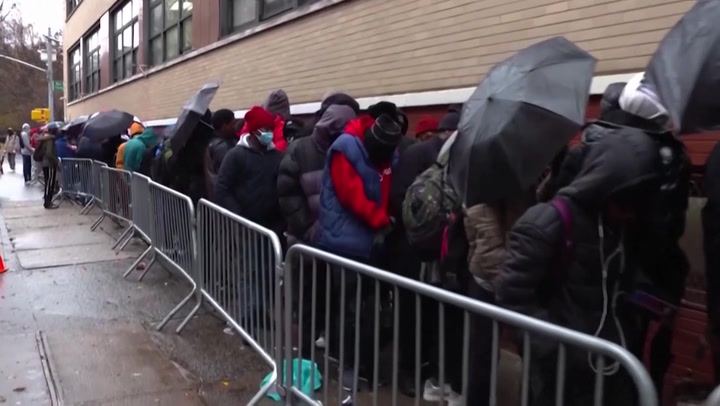 Migrants face bleak winter conditions in tent city outside New York shelter