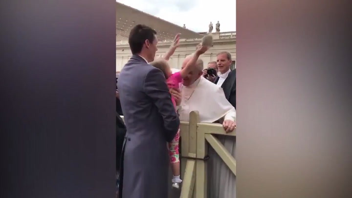 Young girl steals the Pope's hat