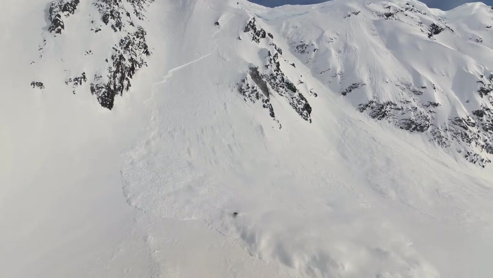 Skier triggers avalanche while cruising down snowy mountain in Alaska