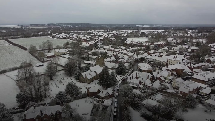 Snow and ice covers UK towns as cold blast continues to disrupt travel