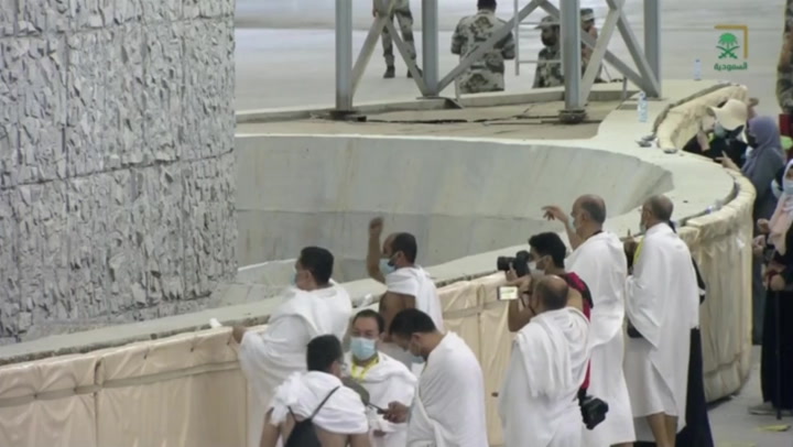 Thousands of Muslim pilgrims throw stones at pillar symbolising Satan as the hajj pilgrimage continues