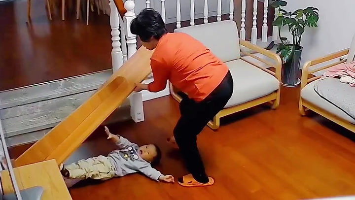 Speedy grandmother saves baby from being crushed by mirror