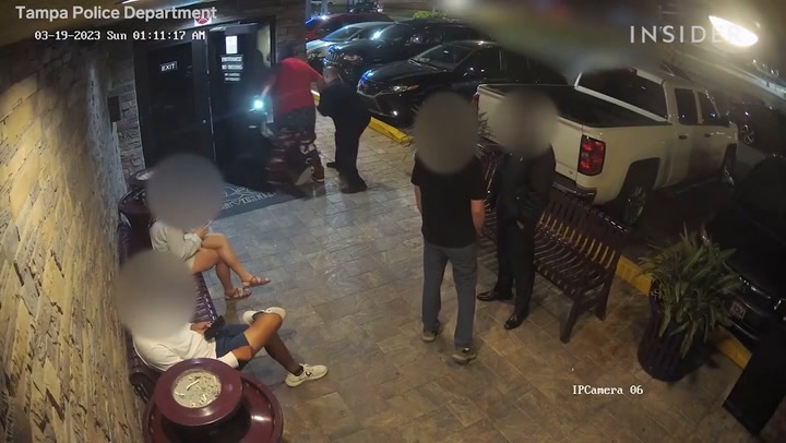 Video shows the dramatic moment a bouncer disarmed and stopped a devil-masked gunman from entering a strip club in Tampa