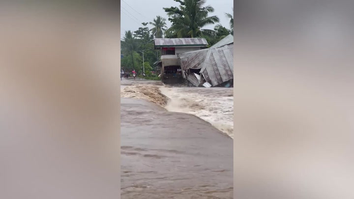 House collapses in raging flood as Philippines hit by torrential rain