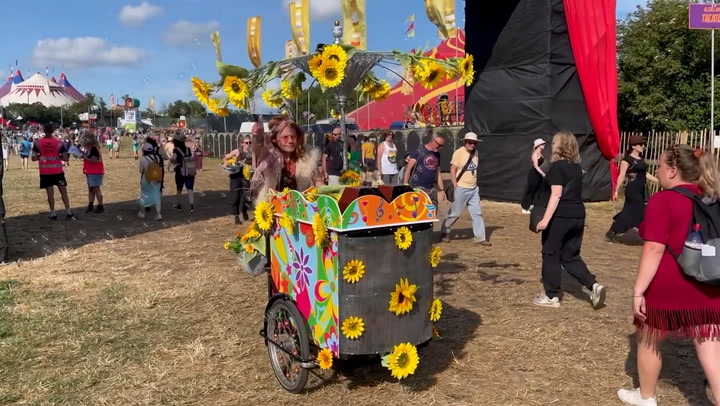 Glastonbury veteran showcases his quirky bike after arriving at festival