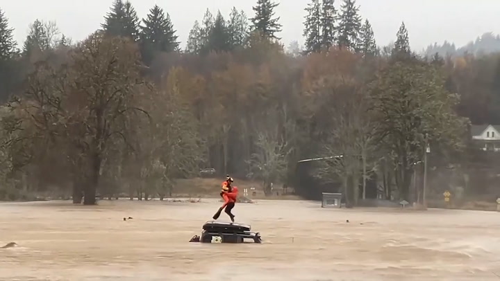 Driver stranded on car roof surrounded by floods rescued by helicopter in Washington