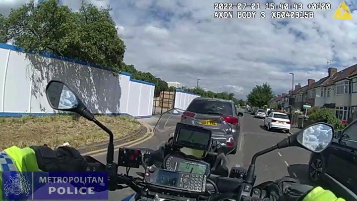 Moment disqualified driver deliberately rams car into police motorbike
