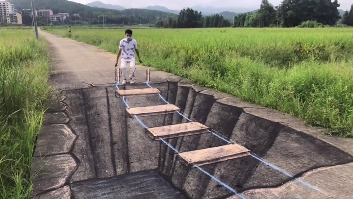 Chinese man uses charcoal and chalk to create impressive 3D perspective art