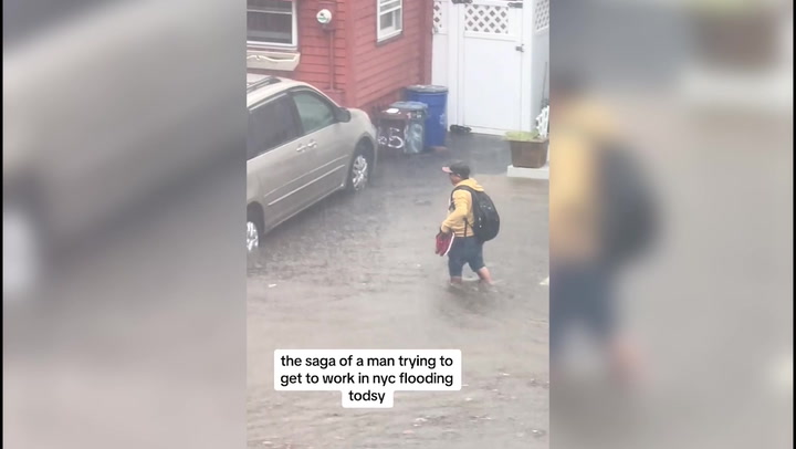 Man wades through knee-deep water amid NYC flash flood warning